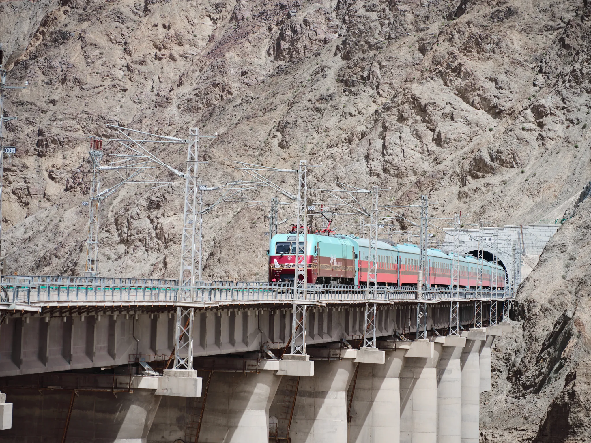 The Silk Road Express luxury train navigating the rugged terrain of Northwest China.webp